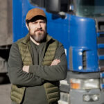 Man Standing in Front of a Truck