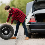 side view of man with spare tyre